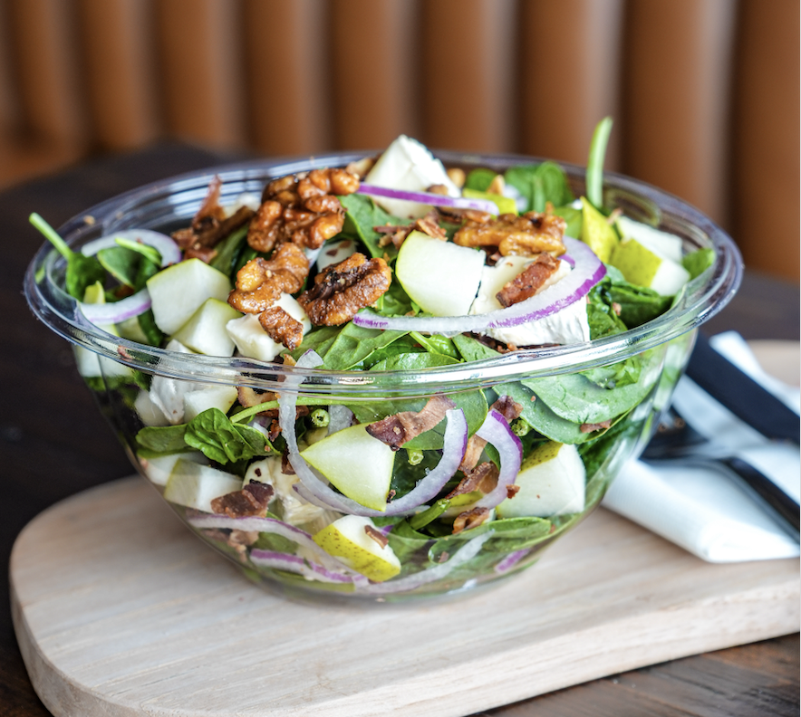 Brie & Champagne salad with spinach, brie, crispy bacon, candied walnuts, pear and red onion