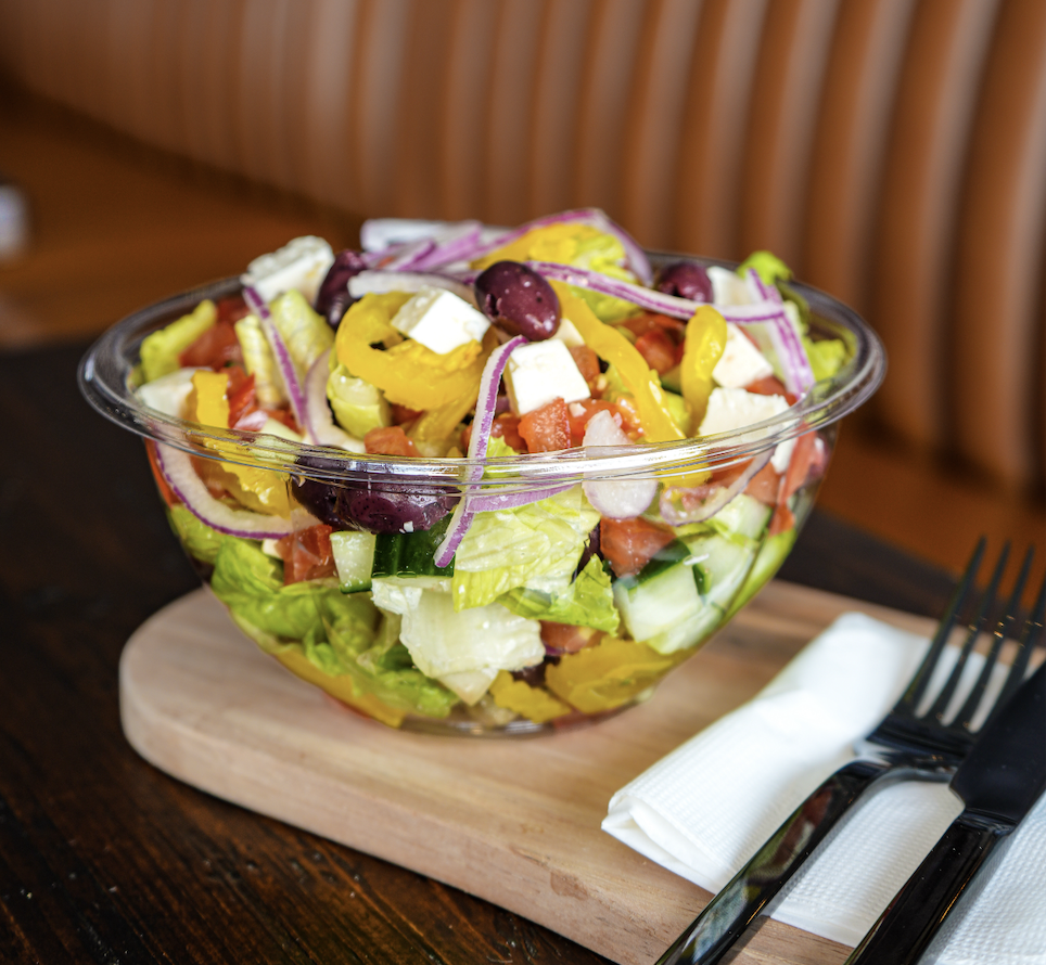The Atlantis salad with romaine, feta, kalamata olives, pepperoncini, cucumber, tomato and creamy Italian dressing